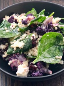 Roasted cauliflower, spinach, couscous, feta and dried cherries create an explosion of taste and texture in this quick, easy and healthy salad recipe. | www.grownupdish.com