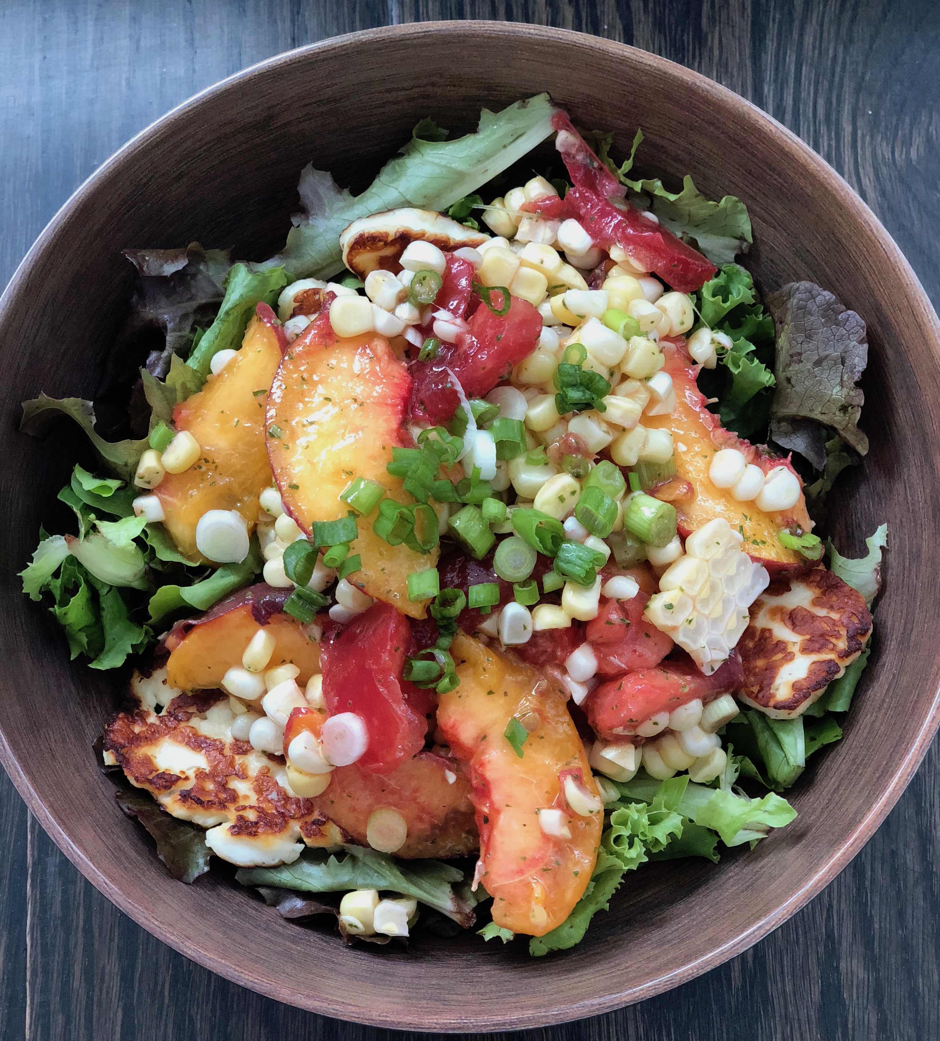 Destined to become your favorite healthy summer salad, this recipe features fresh sweet corn, juicy sweet peaches and tomatoes with a lemon basil vinaigrette. It's Paleo, Whole30, Sugar-Free, Gluten-Free and Vegetarian. | www.grownupdish.com