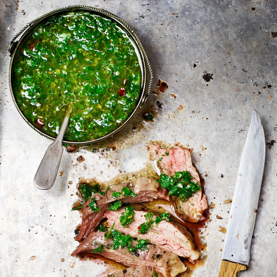 Homemade Paleo Chimichurri Sauce is so much more than just a topper for steaks. It's also delicious on chicken, seafood, potatoes, etc. Chock full of fresh herbs and healthy fats, it will add a boost of flavor to all of your meals. And, you can make it in less than 5 minutes. | www.grownupdish.com