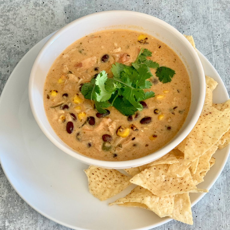 Easy chicken queso soup is cheesy, a little bit spicy, very creamy, very hearty, and oh so delicous. Quick & easy to make with leftover rotisserie chicken. | www.grownupdish.com