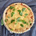 Make a quick and easy southern tomato pie. Tuck ripe tomatoes into a buttery pie crust and top with a layer of melty cheese. It's delicious! | www.grownupdish.com